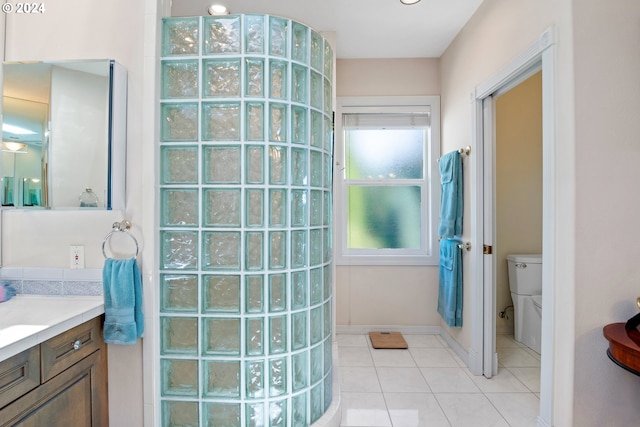 bathroom with vanity, toilet, and tile flooring