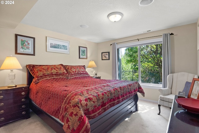 carpeted bedroom featuring a textured ceiling