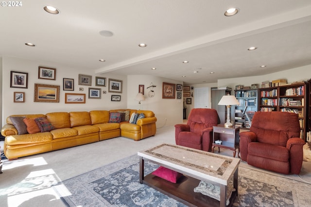 carpeted living room featuring beam ceiling