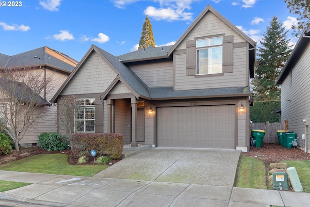 craftsman-style home featuring a front lawn and a garage