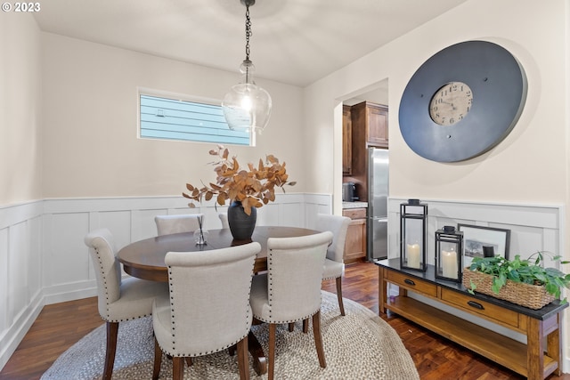 dining room with dark hardwood / wood-style flooring