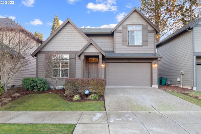 craftsman inspired home featuring a garage and a front lawn