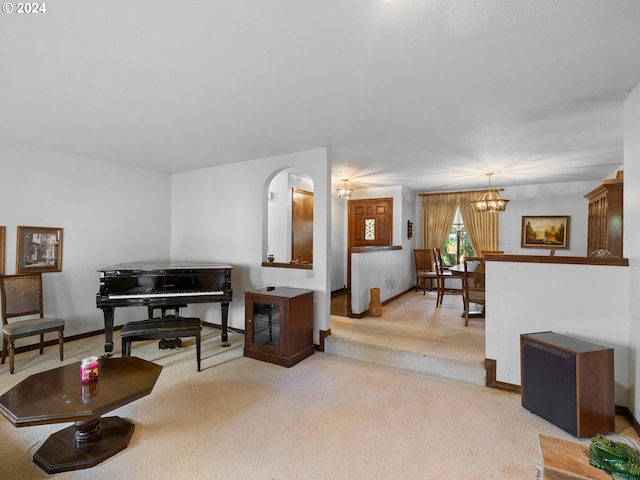 living room with a notable chandelier and light colored carpet