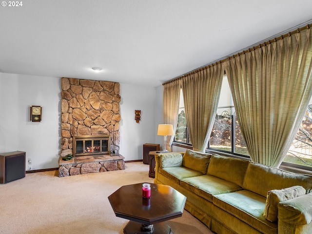 carpeted living room with a stone fireplace and plenty of natural light