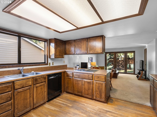 kitchen with light hardwood / wood-style floors, sink, kitchen peninsula, and black dishwasher