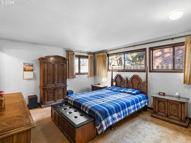 carpeted bedroom featuring a textured ceiling and multiple windows