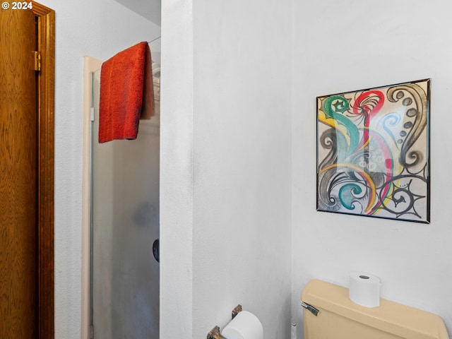 bathroom featuring a shower and toilet