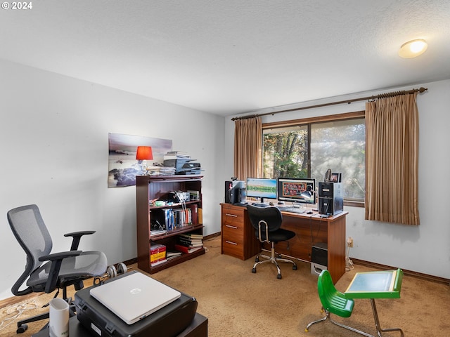 carpeted office featuring a textured ceiling