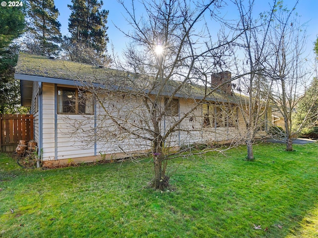 view of side of property with a lawn