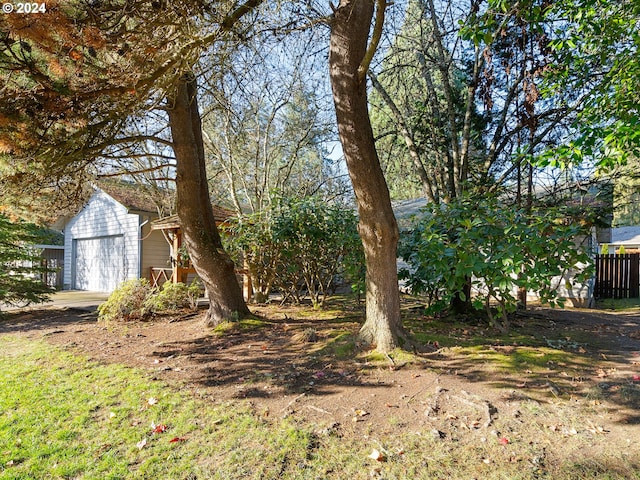 view of yard featuring an outbuilding and a garage