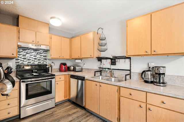 kitchen featuring light brown cabinetry, dark hardwood / wood-style flooring, sink, and stainless steel appliances