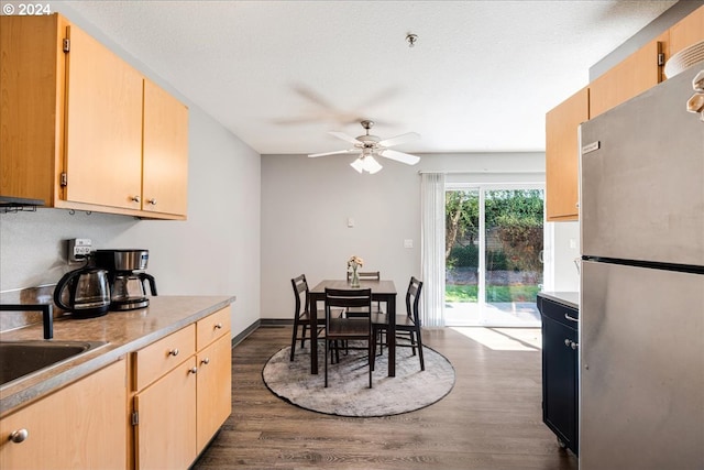 dining room with ceiling fan and dark wood-type flooring