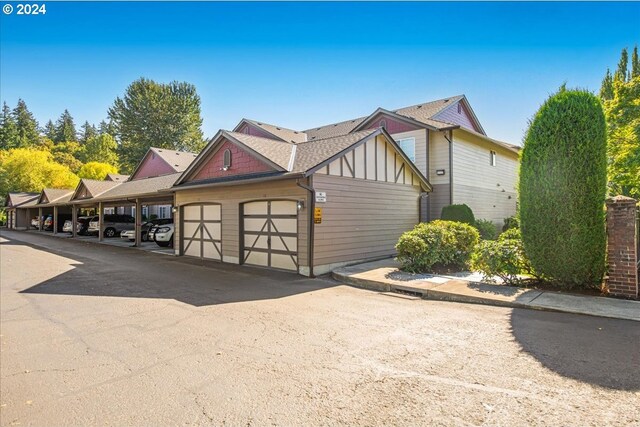 exterior space with a garage and a carport