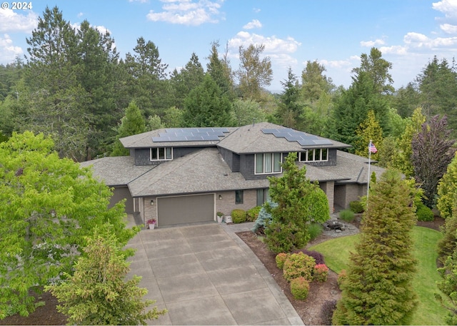 prairie-style home with solar panels and a garage