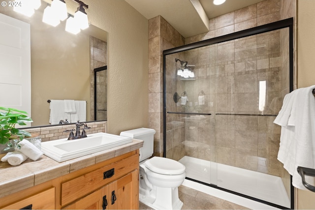 bathroom featuring tasteful backsplash, tile patterned floors, vanity, a shower with door, and toilet