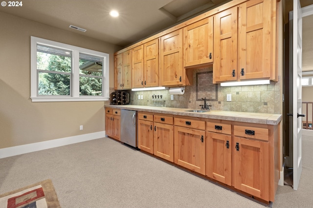 kitchen with light carpet, sink, and stainless steel dishwasher