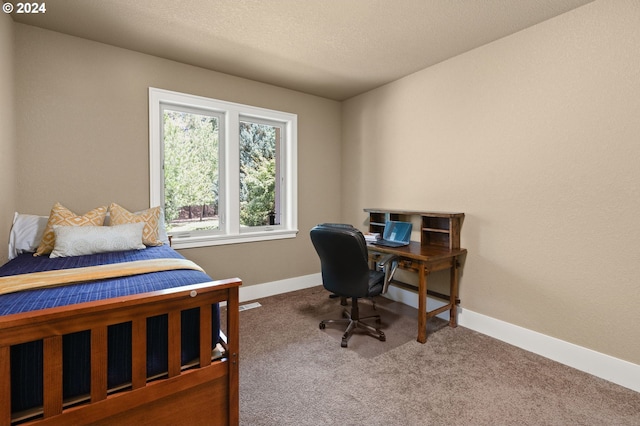 carpeted bedroom featuring a textured ceiling