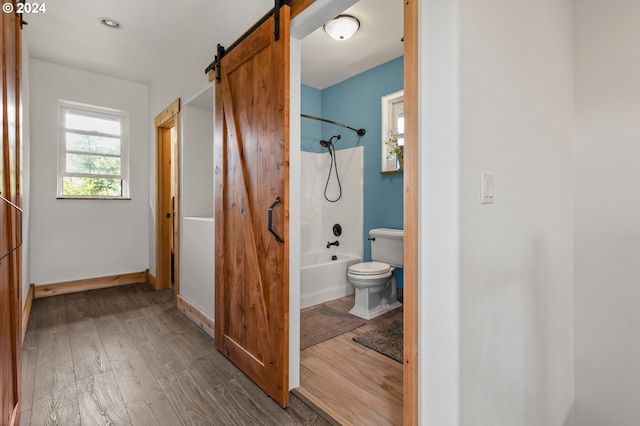 bathroom featuring hardwood / wood-style floors, toilet, and shower / bath combination