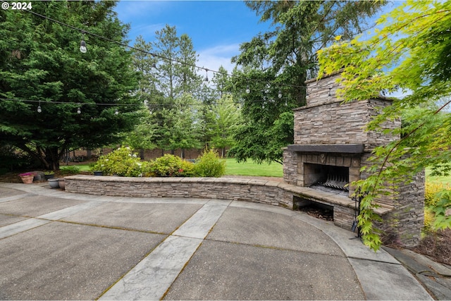 view of patio with an outdoor stone fireplace