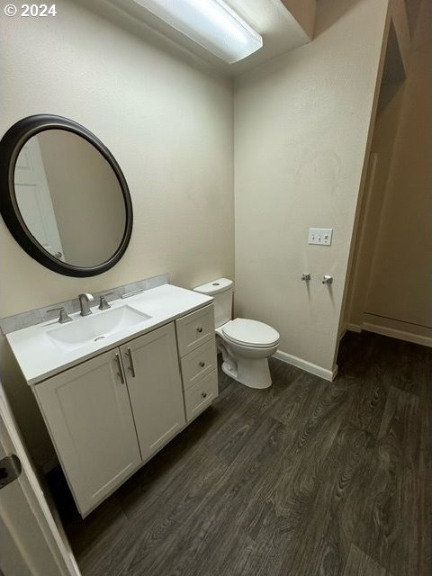 bathroom featuring hardwood / wood-style flooring, vanity, and toilet