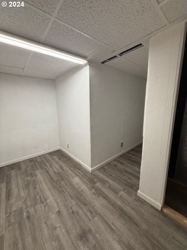 spare room featuring hardwood / wood-style floors and a paneled ceiling