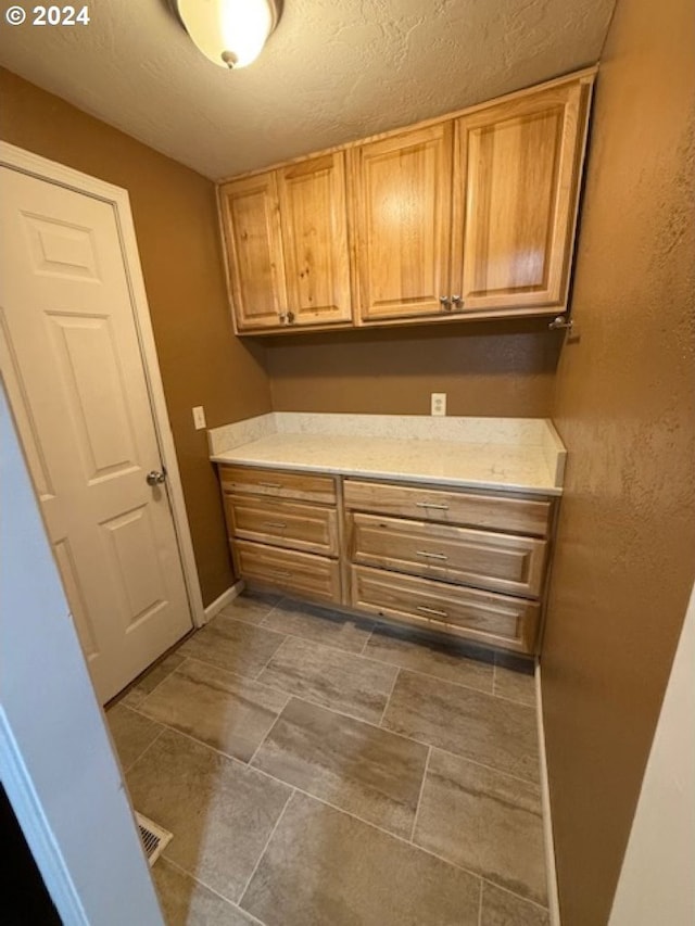 laundry area with a textured ceiling