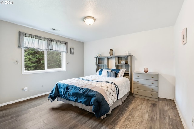 bedroom featuring hardwood / wood-style flooring and a textured ceiling