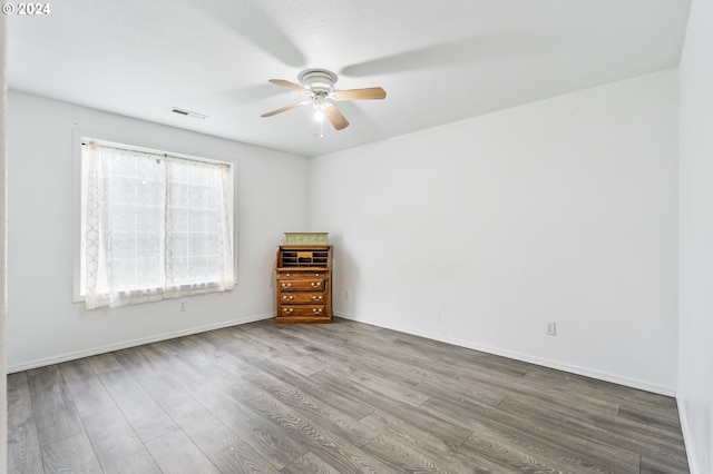 empty room featuring ceiling fan and hardwood / wood-style floors