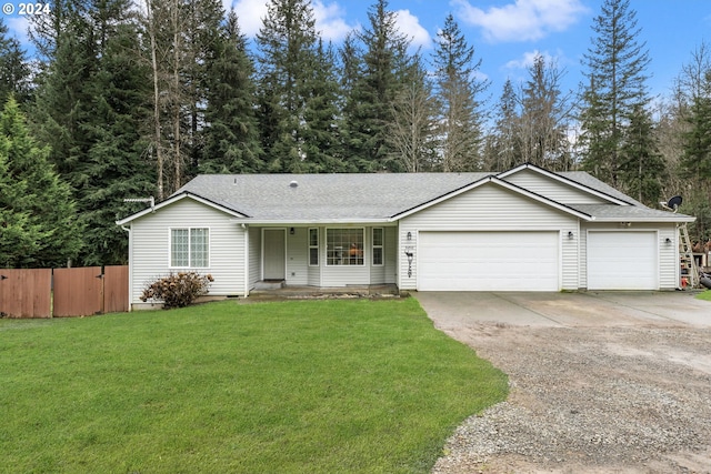 ranch-style house featuring a front yard and a garage