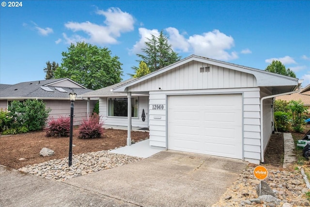 ranch-style home featuring a garage and driveway