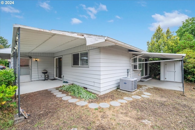 rear view of house with a patio and central AC