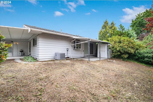 rear view of house with a patio and central AC unit