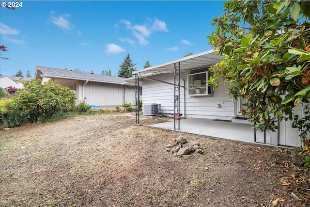 rear view of property featuring a patio and cooling unit