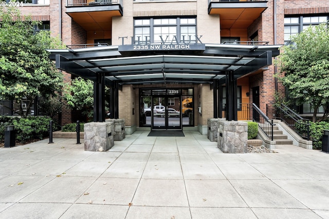 view of exterior entry featuring brick siding