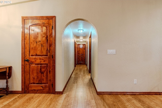 hall with light wood-type flooring