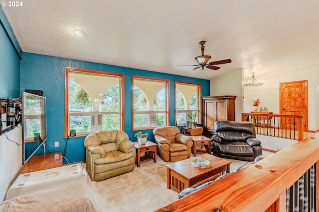 living room with a textured ceiling, ceiling fan with notable chandelier, vaulted ceiling, and carpet