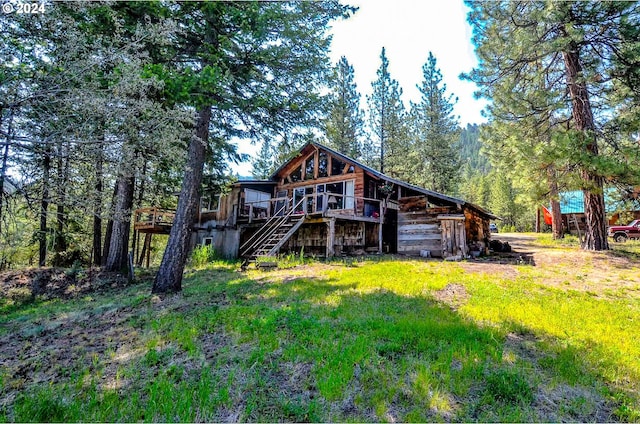 back of property featuring a deck and stairs