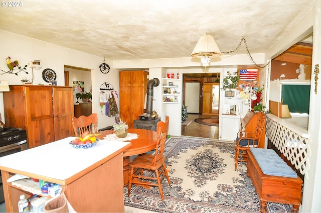 dining space featuring a textured ceiling and a wood stove