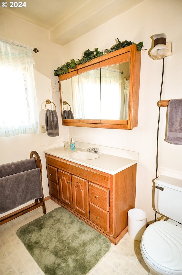 bathroom with vanity, toilet, and tile patterned floors