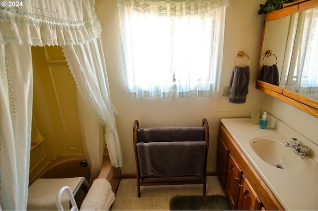 bathroom with shower / tub combo and vanity