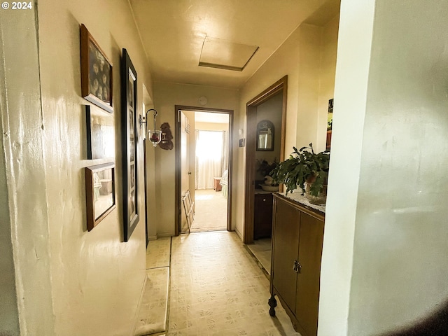 hallway with light colored carpet