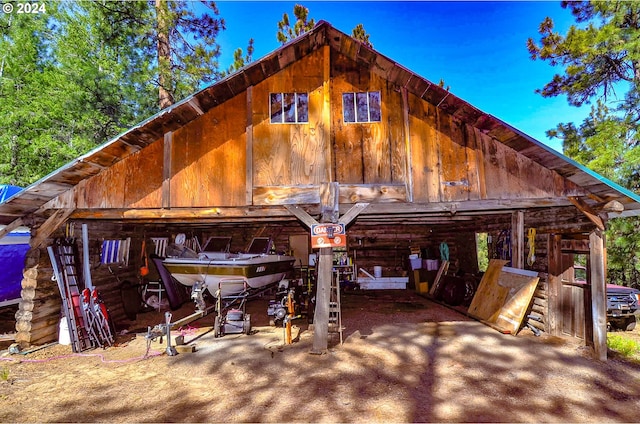 view of front facade with a garage, an outdoor structure, and a barn