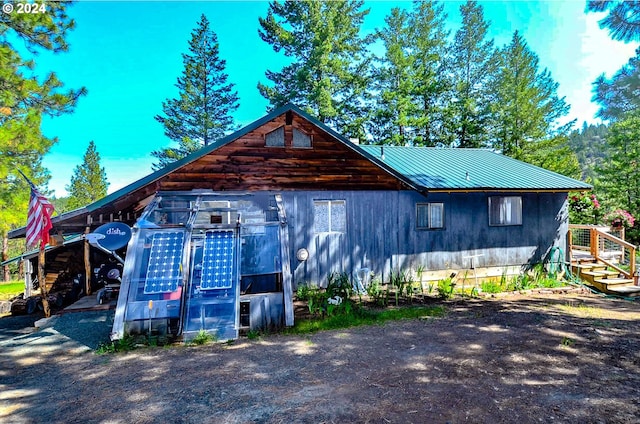 view of front of property with metal roof and a carport