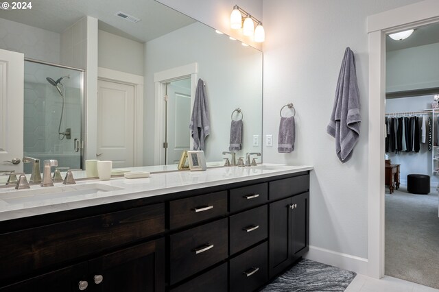 bathroom with vanity, walk in shower, and tile patterned flooring