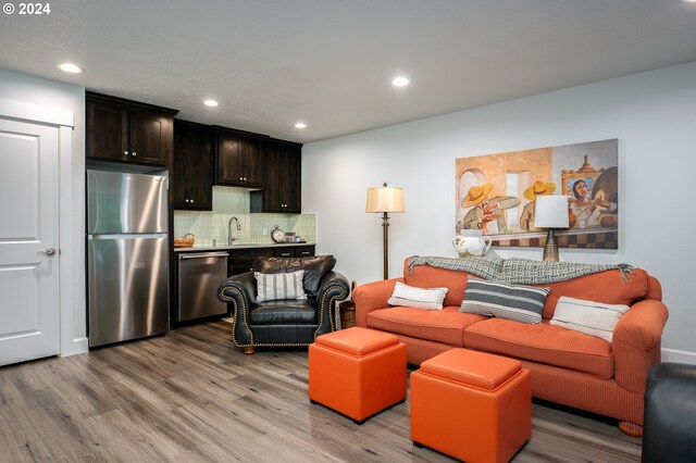 living room with sink and hardwood / wood-style flooring