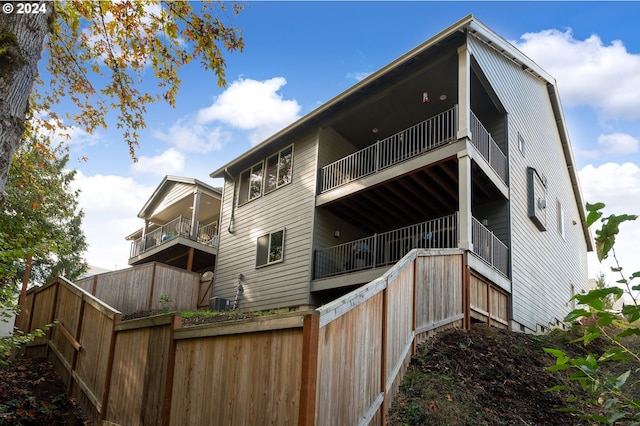 back of house with central AC unit