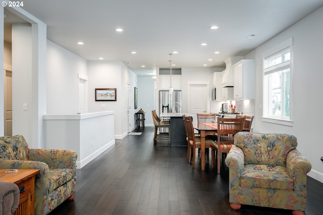 dining space featuring dark wood-type flooring