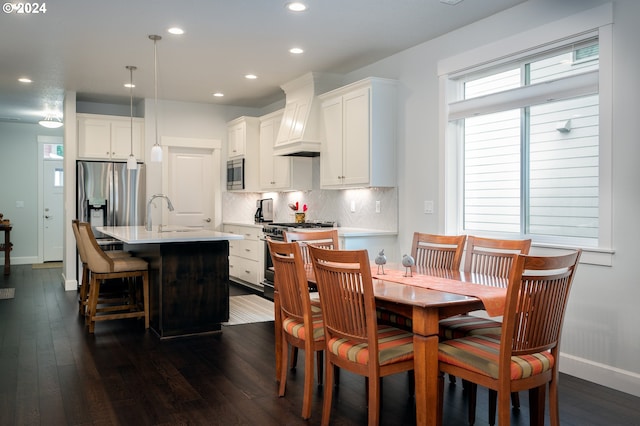 dining room with dark hardwood / wood-style flooring and sink