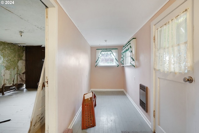 hall with light wood-type flooring and heating unit