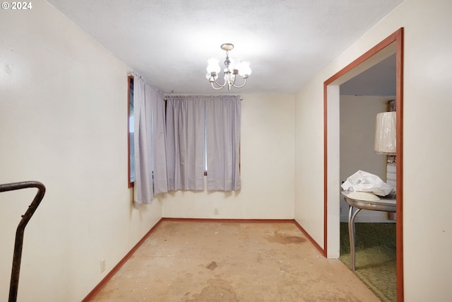 unfurnished room featuring a textured ceiling and an inviting chandelier